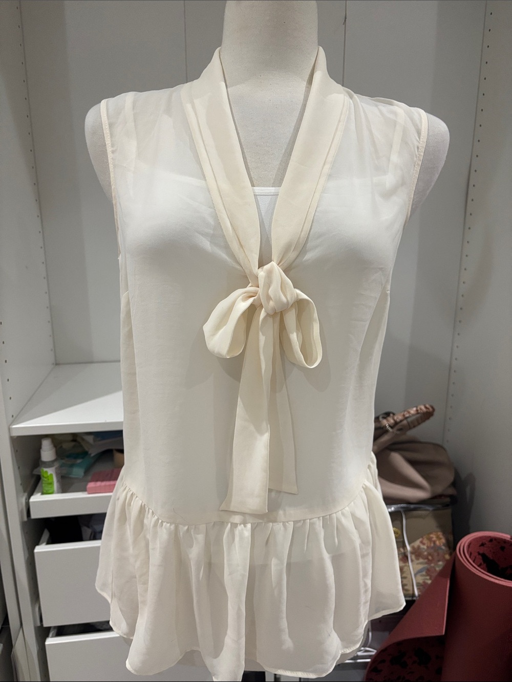 Ivory Sleeveless Tie-Neck Peplum Blouse